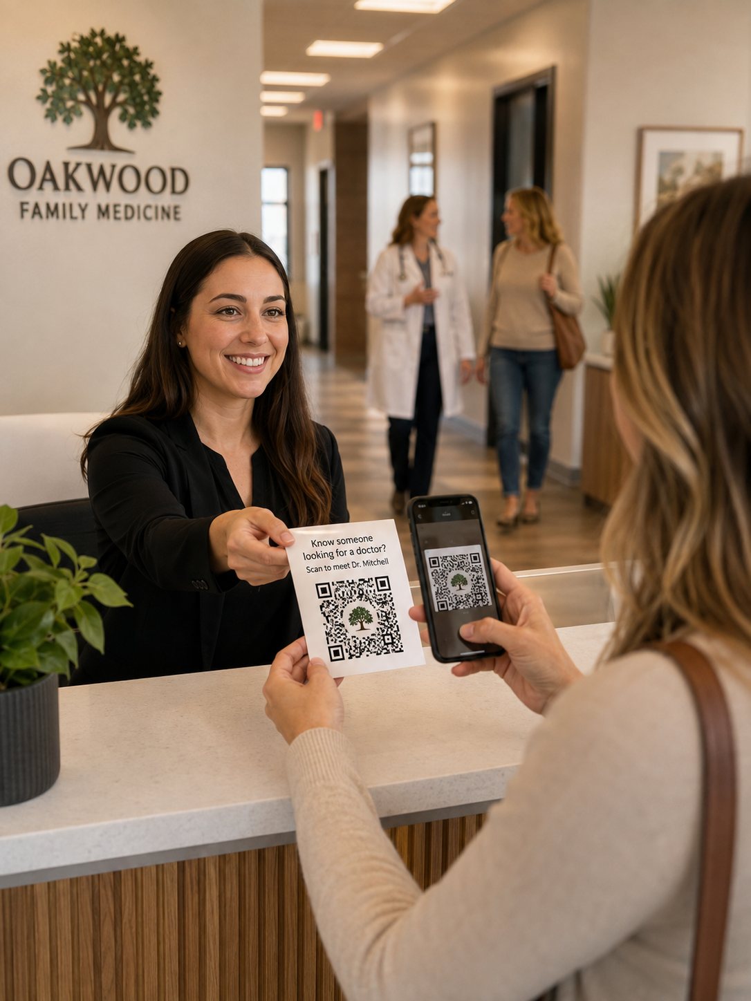 A receptionist handing a patient a referral card with a branded QR code while the doctor walks another patient out